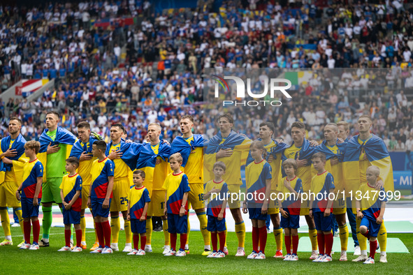 The players of Ukraine are singing the national anthem  during the UEFA EURO 2024 group stage match between Slovakia and Ukraine at Düsseldo...