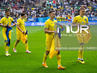 Mykola Matvienko and Volodymyr Brazhko of Ukraine are standing prior to the match  during the UEFA EURO 2024 group stage match between Slova...