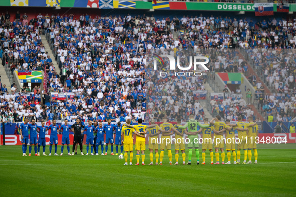 Players of Slovakia and Ukraine are taking part in a minute of silence  during the UEFA EURO 2024 group stage match between Slovakia and Ukr...