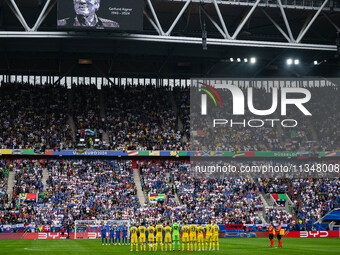 Players of Slovakia and Ukraine are taking part in a minute of silence  during the UEFA EURO 2024 group stage match between Slovakia and Ukr...