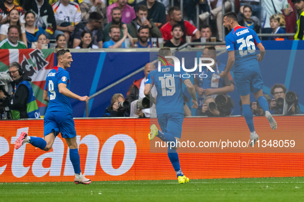 Ivan Schranz of Slovakia is celebrating after scoring his team's first goal with Juraj Kucka and Robert Bozenik of Slovakia  during the UEFA...