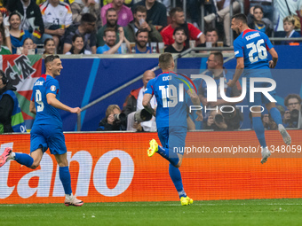 Ivan Schranz of Slovakia is celebrating after scoring his team's first goal with Juraj Kucka and Robert Bozenik of Slovakia  during the UEFA...