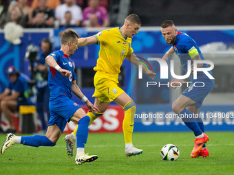 Artem Dovbyk (C) of Ukraine is missing a chance to score against Peter Pekarik (L) and Milan Skriniar (R) of Slovakia  during the UEFA EURO...