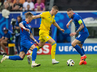 Artem Dovbyk (C) of Ukraine is missing a chance to score against Peter Pekarik (L) and Milan Skriniar (R) of Slovakia  during the UEFA EURO...