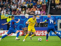 Artem Dovbyk (C) of Ukraine is missing a chance to score against Peter Pekarik (L) and Milan Skriniar (R) of Slovakia  during the UEFA EURO...