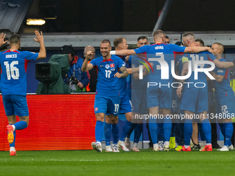 Ivan Schranz of Slovakia is celebrating with his teammates after scoring his team's first goal  during the UEFA EURO 2024 group stage match...