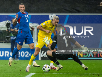 Mykhailo Mudryk of Ukraine is playing against Martin Dubravka of Slovakia (L-R)  during the UEFA EURO 2024 group stage match between Slovaki...