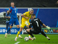 Mykhailo Mudryk of Ukraine is playing against Martin Dubravka of Slovakia (L-R)  during the UEFA EURO 2024 group stage match between Slovaki...