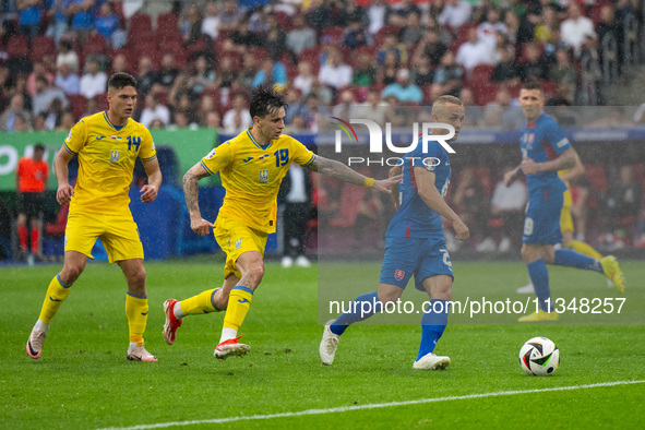 Mykola Shaparenko (C) of Ukraine is confronting Sebastian Kosa (R) of Slovakia  during the UEFA EURO 2024 group stage match between Slovakia...