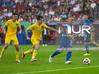 Mykola Shaparenko (C) of Ukraine is confronting Sebastian Kosa (R) of Slovakia  during the UEFA EURO 2024 group stage match between Slovakia...