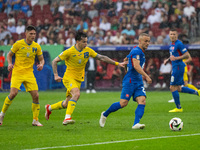 Mykola Shaparenko (C) of Ukraine is confronting Sebastian Kosa (R) of Slovakia  during the UEFA EURO 2024 group stage match between Slovakia...