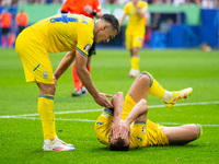 Oleksandr Tymchyk and Andriy Yarmolenko of Ukraine are standing (L-R)  during the UEFA EURO 2024 group stage match between Slovakia and Ukra...