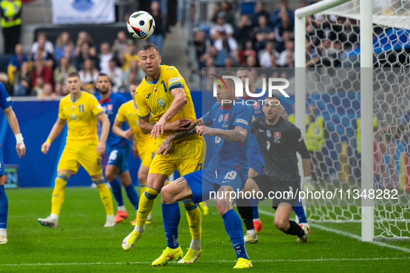 Ruslan Malinovskyi of Ukraine is battling for possession with Juraj Kucka of Slovakia (L-R)  during the UEFA EURO 2024 group stage match bet...