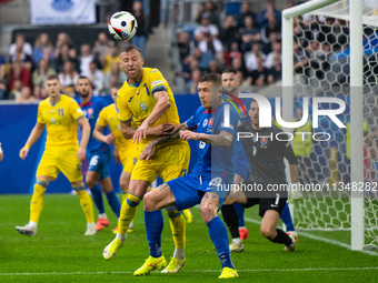 Ruslan Malinovskyi of Ukraine is battling for possession with Juraj Kucka of Slovakia (L-R)  during the UEFA EURO 2024 group stage match bet...