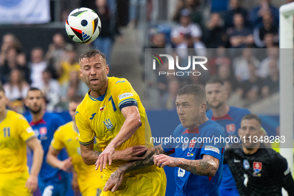 Ruslan Malinovskyi of Ukraine is battling for possession with Juraj Kucka of Slovakia (L-R)  during the UEFA EURO 2024 group stage match bet...