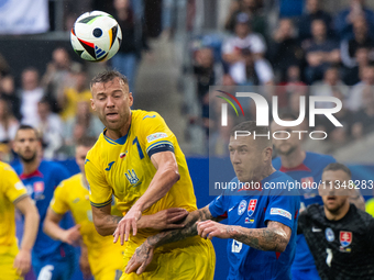 Ruslan Malinovskyi of Ukraine is battling for possession with Juraj Kucka of Slovakia (L-R)  during the UEFA EURO 2024 group stage match bet...