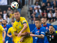 Ruslan Malinovskyi of Ukraine is battling for possession with Juraj Kucka of Slovakia (L-R)  during the UEFA EURO 2024 group stage match bet...