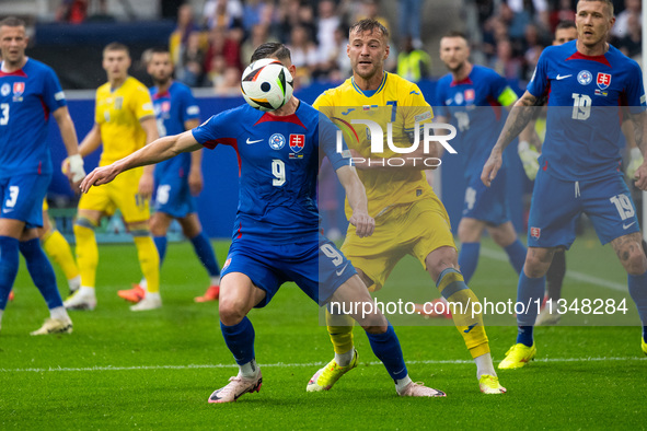 Robert Bozenik of Slovakia is battling for possession with Andriy Yarmolenko of Ukraine (L-R)  during the UEFA EURO 2024 group stage match b...