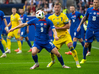 Robert Bozenik of Slovakia is battling for possession with Andriy Yarmolenko of Ukraine (L-R)  during the UEFA EURO 2024 group stage match b...