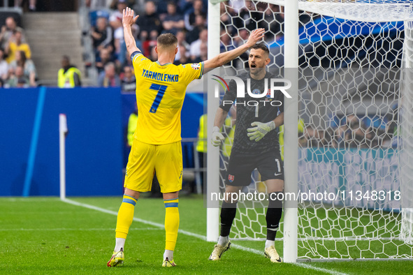 Andriy Yarmolenko of Ukraine is confronting Martin Dubravka of Slovakia (L-R)  during the UEFA EURO 2024 group stage match between Slovakia...