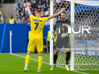 Andriy Yarmolenko of Ukraine is confronting Martin Dubravka of Slovakia (L-R)  during the UEFA EURO 2024 group stage match between Slovakia...