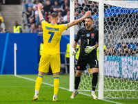 Andriy Yarmolenko of Ukraine is confronting Martin Dubravka of Slovakia (L-R)  during the UEFA EURO 2024 group stage match between Slovakia...