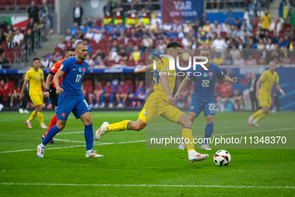 Oleksandr Tymchyk of Ukraine is shooting  during the UEFA EURO 2024 group stage match between Slovakia and Ukraine at Dusseldorf Arena on Ju...