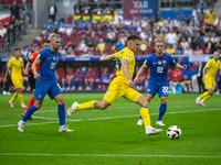 Oleksandr Tymchyk of Ukraine is shooting  during the UEFA EURO 2024 group stage match between Slovakia and Ukraine at Dusseldorf Arena on Ju...