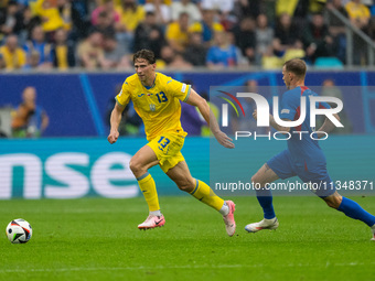 Ilya Zabarnyi of Ukraine is playing against Ondrej Duda of Slovakia  during the UEFA EURO 2024 group stage match between Slovakia and Ukrain...