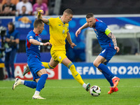 Artem Dovbyk (C) of Ukraine is missing a chance to score against Peter Pekarik (L) and Milan Skriniar (R) of Slovakia  during the UEFA EURO...