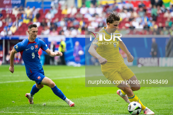 Robert Bozenik of Slovakia is confronting Ilya Zabarnyi of Ukraine (L-R)  during the UEFA EURO 2024 group stage match between Slovakia and U...