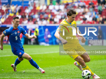 Robert Bozenik of Slovakia is confronting Ilya Zabarnyi of Ukraine (L-R)  during the UEFA EURO 2024 group stage match between Slovakia and U...