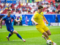 Robert Bozenik of Slovakia is confronting Ilya Zabarnyi of Ukraine (L-R)  during the UEFA EURO 2024 group stage match between Slovakia and U...