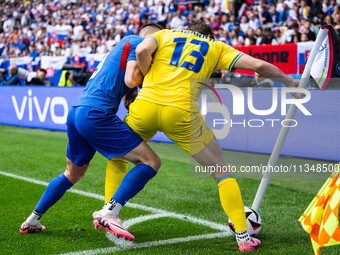 Robert Bozenik of Slovakia is confronting Ilya Zabarnyi of Ukraine (L-R)  during the UEFA EURO 2024 group stage match between Slovakia and U...