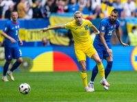 Mykhailo Mudryk of Ukraine is playing against Ivan Schranz of Slovakia (L-R)  during the UEFA EURO 2024 group stage match between Slovakia a...