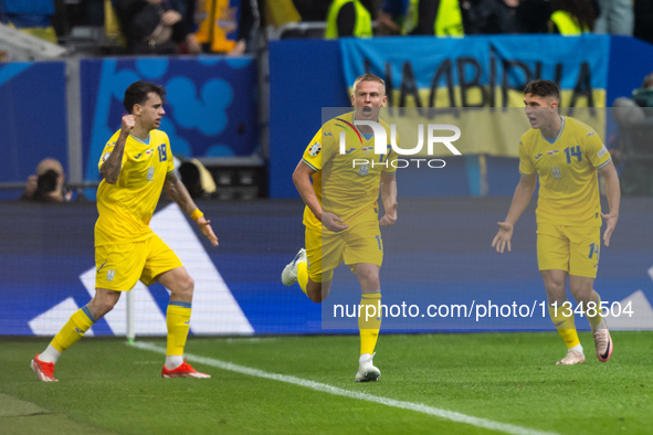 Mykola Shaparenko (L) of Ukraine is celebrating after scoring his team's first goal with Oleksandr Zinchenko (C) and Georgiy Sudakov (R) of...