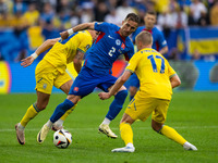 Peter Pekarik of Slovakia is battling for possession with Mykhailo Mudryk and Oleksandr Zinchenko of Ukraine  during the UEFA EURO 2024 grou...