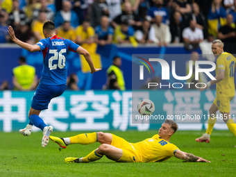 Ivan Schranz of Slovakia is playing against Volodymyr Brazhko of Ukraine  during the UEFA EURO 2024 group stage match between Slovakia and U...