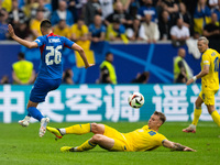 Ivan Schranz of Slovakia is playing against Volodymyr Brazhko of Ukraine  during the UEFA EURO 2024 group stage match between Slovakia and U...