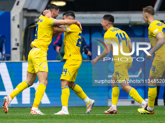 Roman Yaremchuk of Ukraine is celebrating after scoring his team's second goal with Oleksandr Tymchyk, Georgiy Sudakov, and Volodymyr Brazhk...