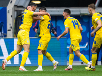 Roman Yaremchuk of Ukraine is celebrating after scoring his team's second goal with Oleksandr Tymchyk, Georgiy Sudakov, and Volodymyr Brazhk...