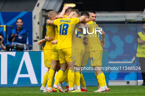 Roman Yaremchuk of Ukraine is celebrating after scoring his team's second goal with his teammates  during the UEFA EURO 2024 group stage mat...