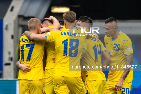 Roman Yaremchuk of Ukraine is celebrating after scoring his team's second goal with his teammates  during the UEFA EURO 2024 group stage mat...