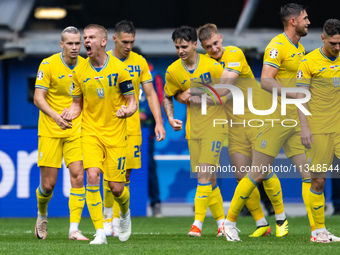 Roman Yaremchuk of Ukraine is celebrating after scoring his team's second goal with his teammates  during the UEFA EURO 2024 group stage mat...