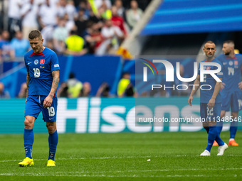 Juraj Kucka and Stanislav Lobotka (L-R) of Slovakia are looking dejected after Ukraine's second goal  during the UEFA EURO 2024 group stage...