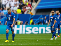 Juraj Kucka and Stanislav Lobotka (L-R) of Slovakia are looking dejected after Ukraine's second goal  during the UEFA EURO 2024 group stage...