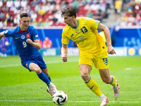 Robert Bozenik of Slovakia is confronting Ilya Zabarnyi of Ukraine (L-R)  during the UEFA EURO 2024 group stage match between Slovakia and U...