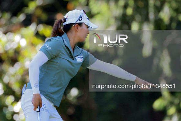 Jin Young Ko of Republic of Korea communicates with her caddie as she prepares to putt on the 9th green during the first round of the KPMG W...