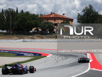 Daniel Ricciardo of RB and Lewis Hamilton of Mercedes during first practice ahead of the Formula 1 Spanish Grand Prix at Circuit de Barcelon...