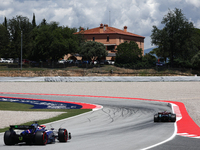 Daniel Ricciardo of RB and Lewis Hamilton of Mercedes during first practice ahead of the Formula 1 Spanish Grand Prix at Circuit de Barcelon...